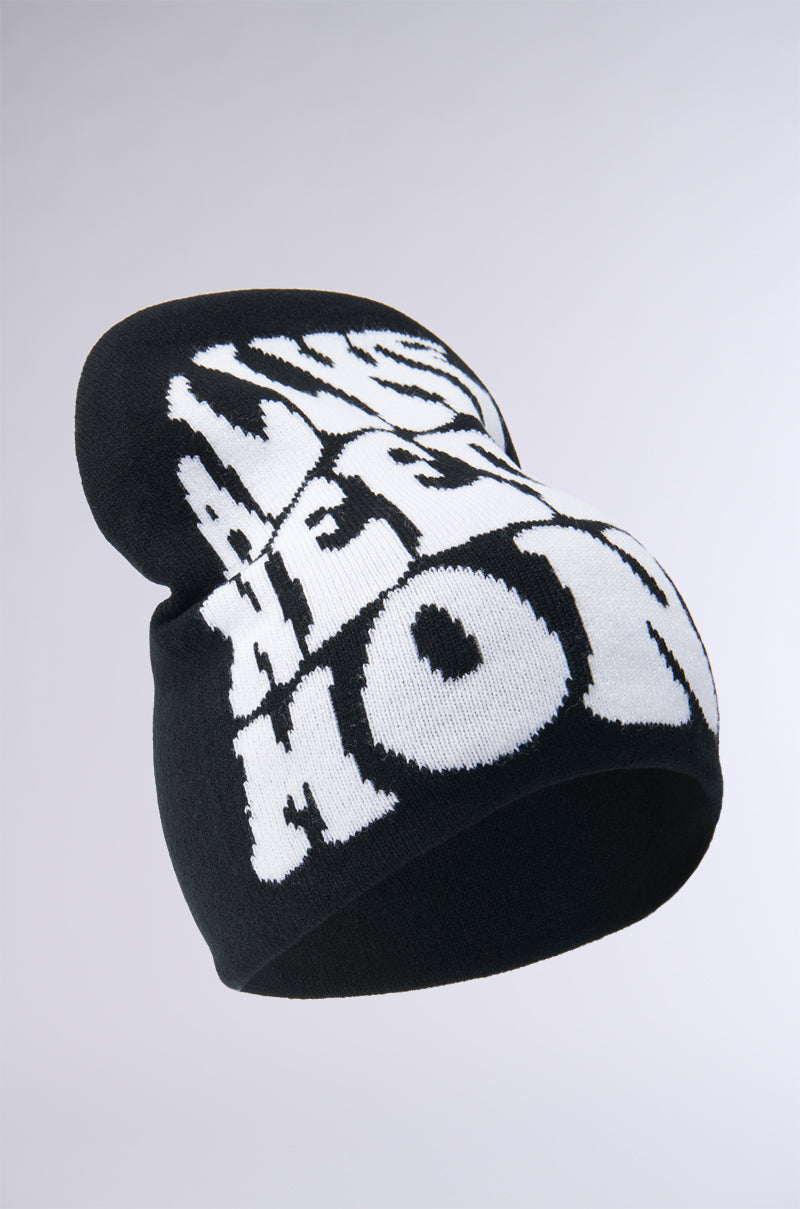 The ALL WE NEED IS MONEY BLACK BEANIE features bold, white, distorted graffiti-style text on a black acrylic knit. A gradient background from white to light gray enhances the beanie's standout design. 4