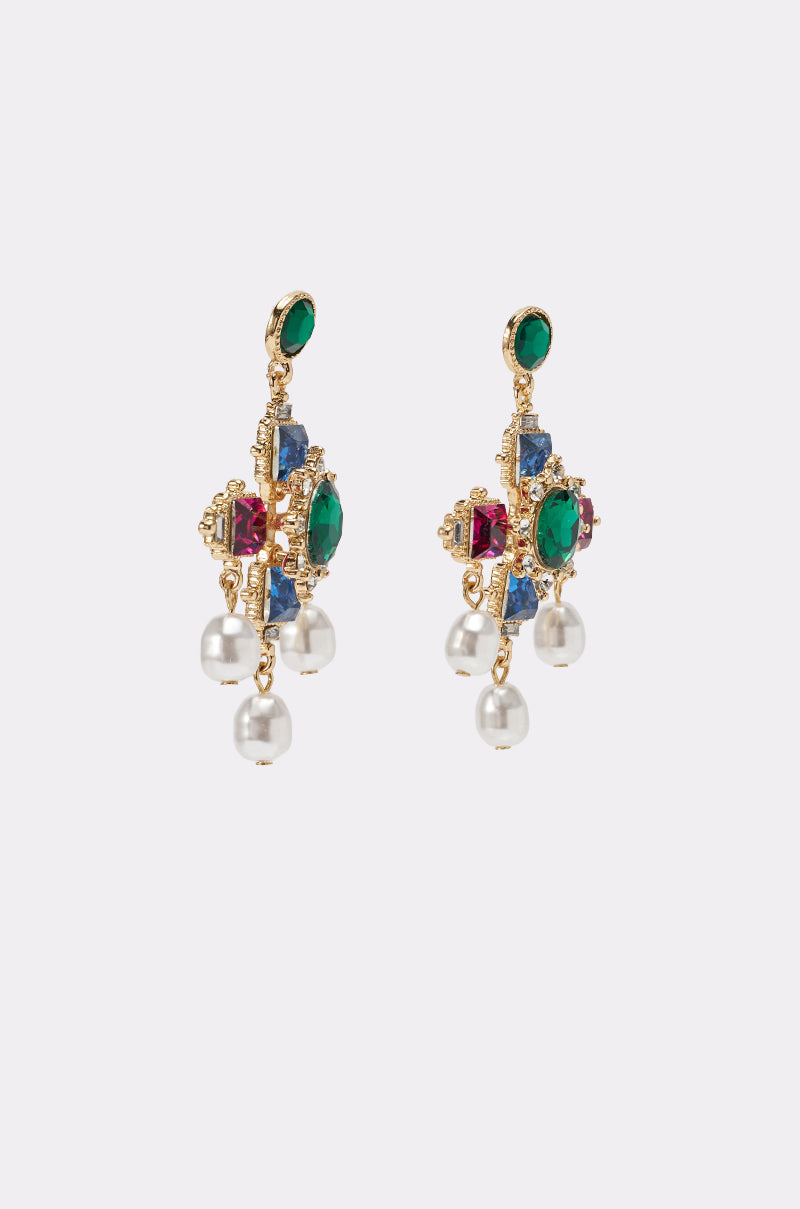 GLAM EARRING: Gold statement earrings with green, blue, and red gemstones. Each earring features three dangling white pearls against a plain light background. 2