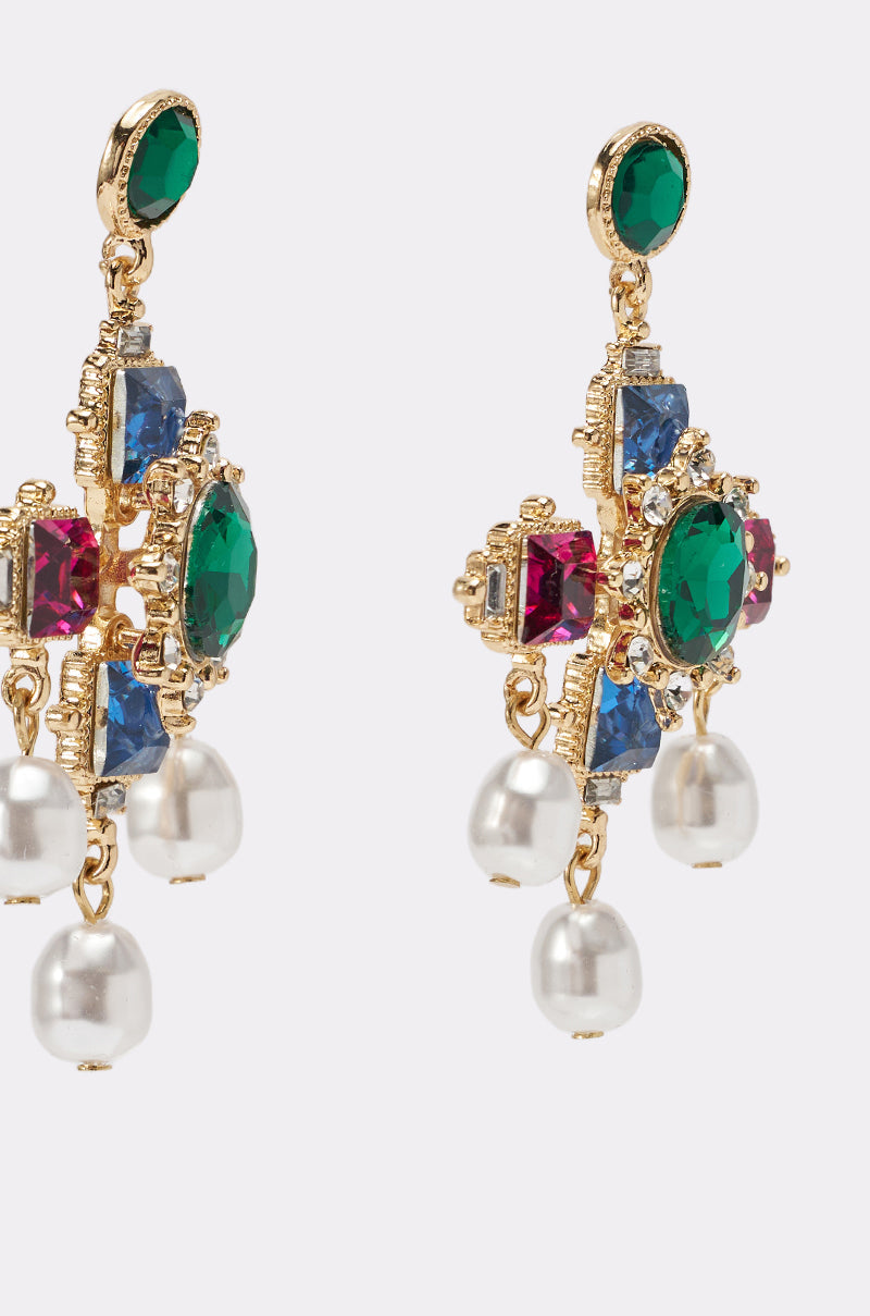 The GLAM EARRING features ornate gold design with green, blue, and pink gemstones, crystal accents, and three hanging white pearl-like beads on each earring. 3