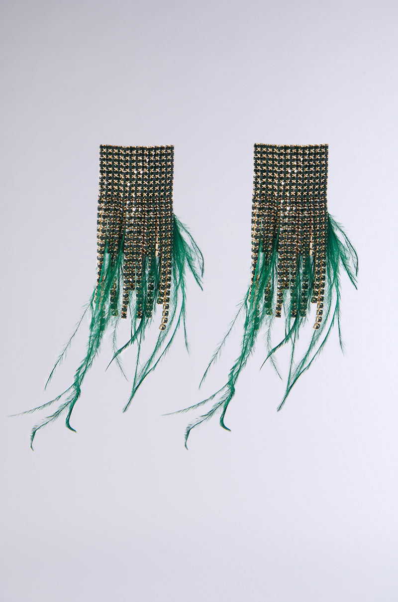 Introducing the PENELOPE FEATHER EARRING: a stunning pair of gold chainlink fringe earrings adorned with vibrant green feathers that cascade elegantly. Set against a simple light gray background, these earrings' refined design truly stands out.
