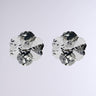 The image showcases two PICTURE PERFECT EARRING clusters, akin to abstract floral designs, crafted from shiny, metallic faux silver minerals. Set against a plain light gray background, these clusters gleam with reflective surfaces and intricate angles, reminiscent of statement earrings with geometric flair.