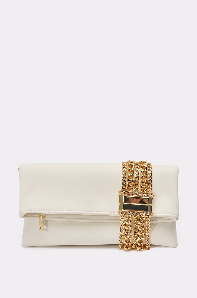 The KIMMY CLUTCH is a white faux leather evening bag with a gold zipper and a decorative gold chain detail wrapped around one end, secured by a rectangular gold accent. 0