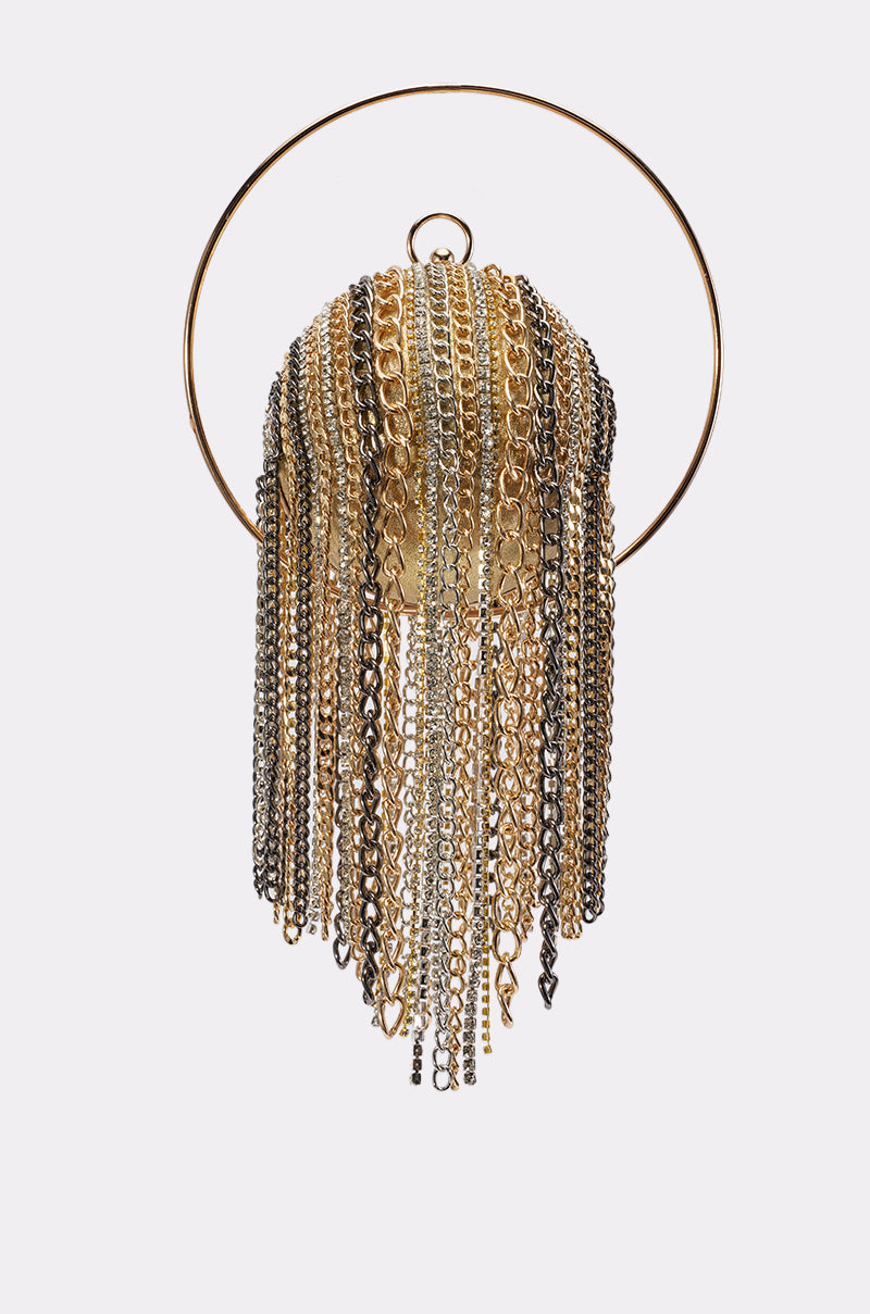 The I DONT CARE CHAIN PURSE features layered gold, silver, and black chains suspended from a circular gold frame against a plain white background, evoking the striking look of a sculptural gold jellyfish or the dramatic fringe of a mixed-metal evening bag.