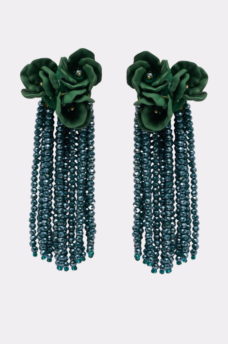 The BERLIN EARRING is a pair of floral drop earrings with dark green flower tops and multiple strands of teal beaded fringe cascading from each piece. 2