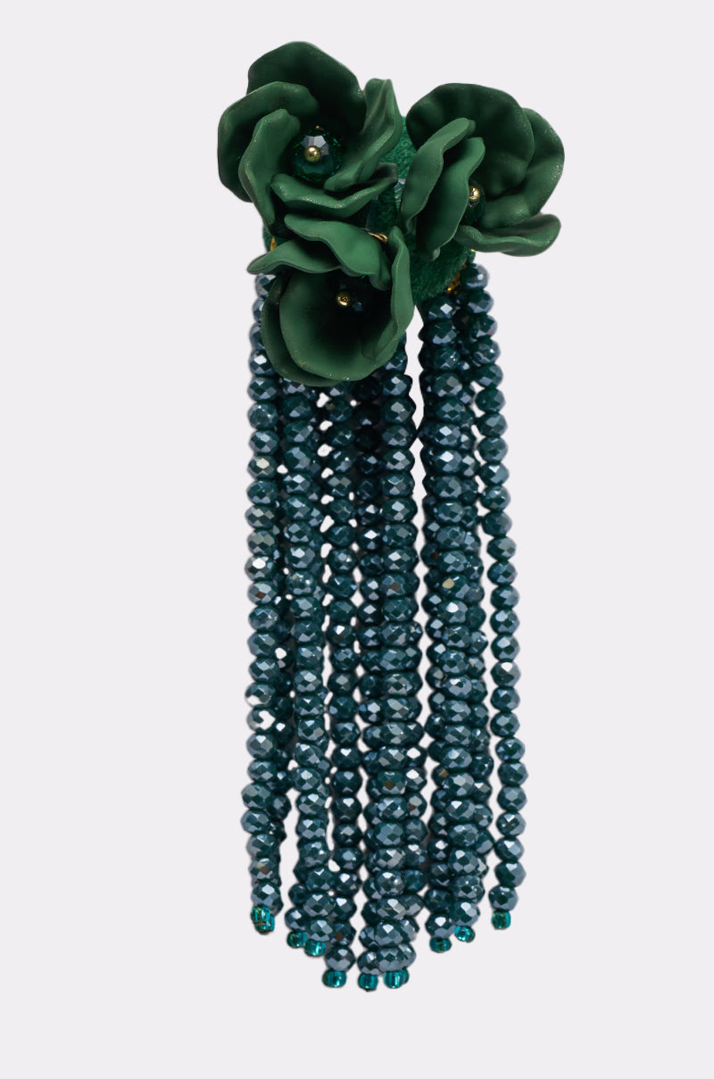 The BERLIN EARRING is a decorative pair of drop earrings with green ceramic flowers at the top and dark green faceted beaded fringe strands hanging below. 3