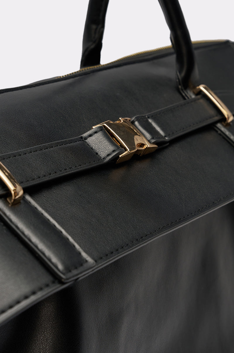 Close-up of the TAKE A PIC OVERSIZED SLOUCH TOTE in black leather, featuring gold-tone buckle hardware and handles, showcasing its textured finish and elegant design details against a neutral background. 3