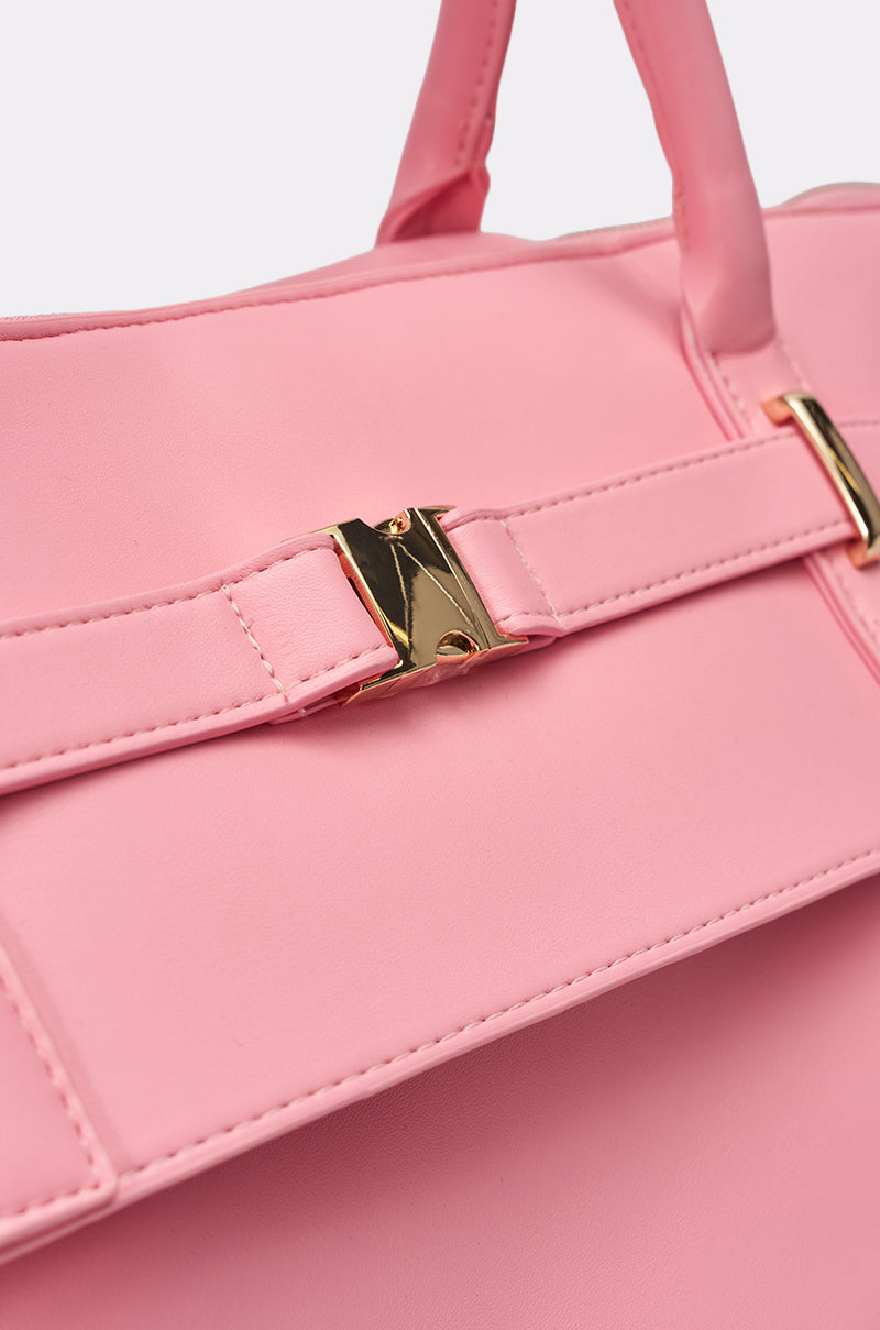 Close-up of the TAKE A PIC OVERSIZED SLOUCH TOTE IN PINK, featuring pink faux leather, gold-tone hardware, a belt-style top strap, shiny gold clasp, and removable crossbody strap against a plain background. 3