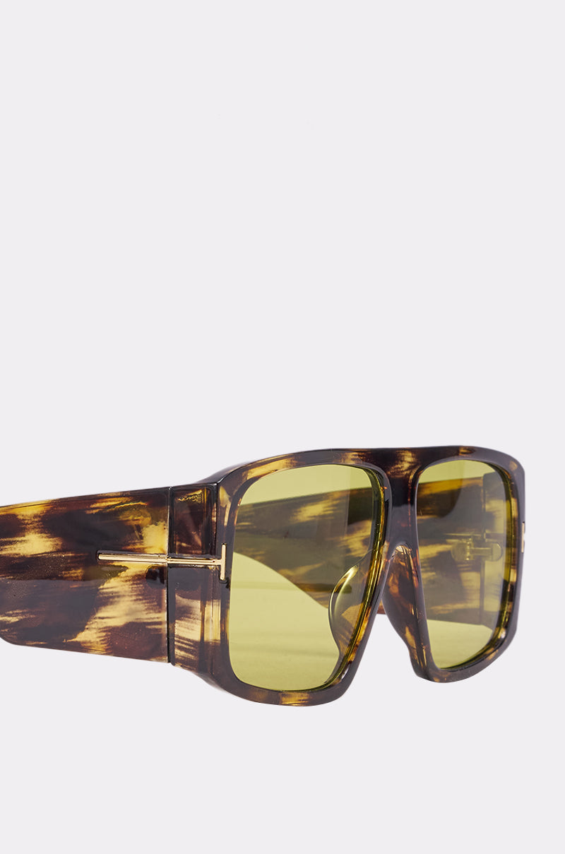 Close-up of WATCH YOURSELF SUNGLASSES featuring an oversized tortoise shell design with a thick frame and large rectangular yellow-tinted lenses, displayed against a plain light background. 4