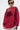 A person with short dark hair, large sunglasses, and hoop earrings wears an oversized OPEN FOR BUSINESS SWEATSHIRT IN BURGUNDY over a black top and light blue jeans, carrying a black bag against a plain white background.