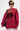 A person with short dark hair and large sunglasses models the OPEN FOR BUSINESS SWEATSHIRT IN BURGUNDY with mesh cutouts, paired with light jeans and a black crossbody bag against a plain light background.