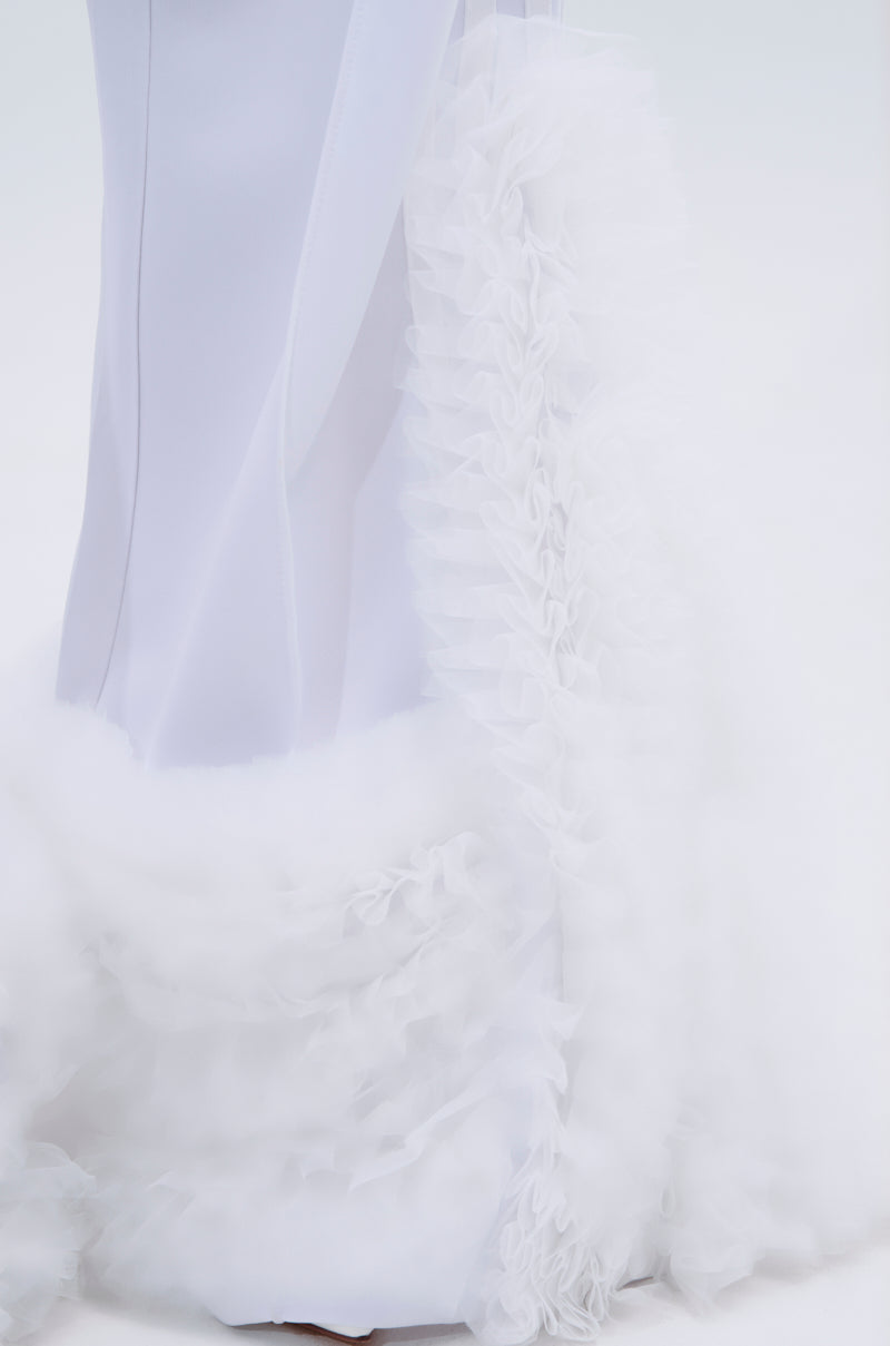 A close-up of the lower half of a person wearing the MODERN JAM TRACK PANT IN WHITE, featuring sheer ruffled tulle details and fluffy cloud-like trim at the hem and sides against a plain light-colored background.