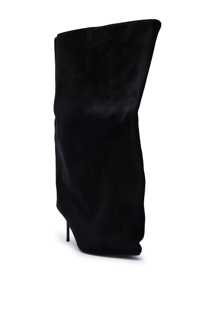 The AZALEA WANG ABAWI BLACK EXTREME BOOT IN SUEDE, featuring a slouchy design, pointed toe, and stiletto heel, is shown in black suede at an angle against a white background.