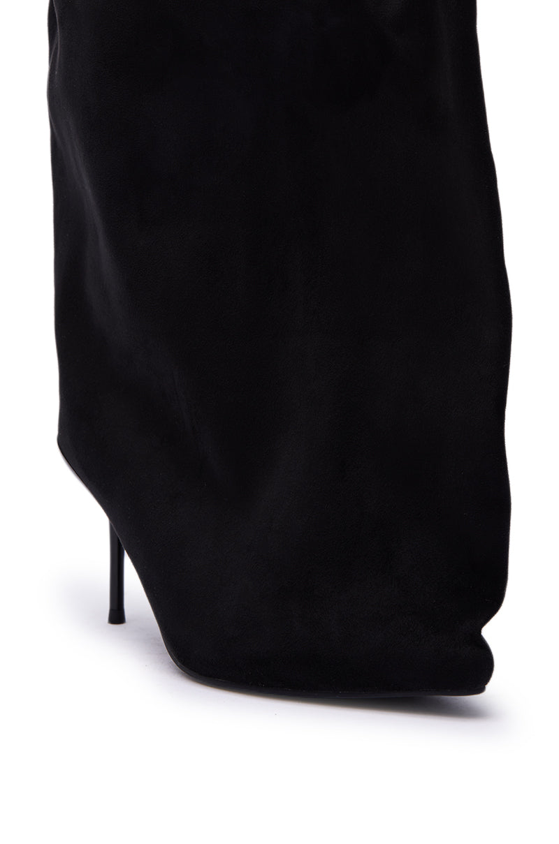 Close-up of the heel and lower section of the AZALEA WANG ABAWI BLACK EXTREME BOOT IN SUEDE, showcasing its pointed toe, slim stiletto heel, and soft suede-like texture.