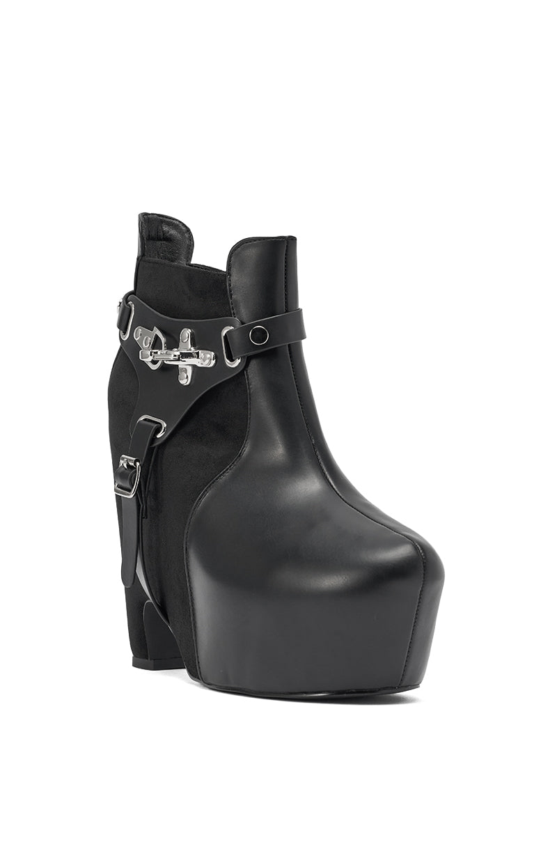 The AZALEA WANG ABYSS BLACK WEDGE PLATFORM BOOTIE is a black faux leather bootie with a side buckle and a stylish chunky wedge platform heel. 5