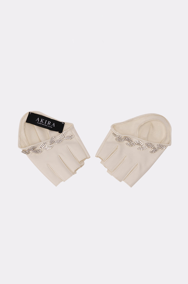 The GET WITH IT GLOVES are cream-colored, fingerless gloves with rhinestone appliques at the wrist, shown on a white background. One glove displays an "AKIRA" brand tag for a signature detail. 2
