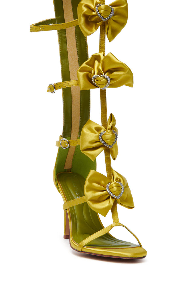The AZALEA WANG AERIN LIME BOW EMBELLISHED GLADIATOR STILETTO SANDAL is a chic knee-high design with bow-adorned straps, each featuring a rhinestone heart-shaped buckle. It includes a medium stiletto heel and a green sole with comfort cushion insole for enhanced comfort. 6