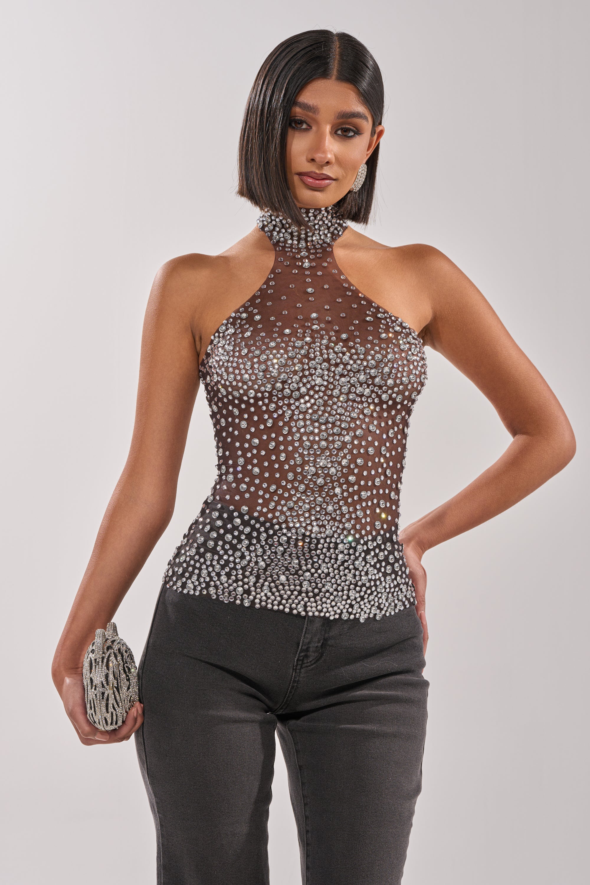 A woman in the ALL YEAR ROUND SHEER RHINESTONE TOP—a black and white mock-neck style. 1