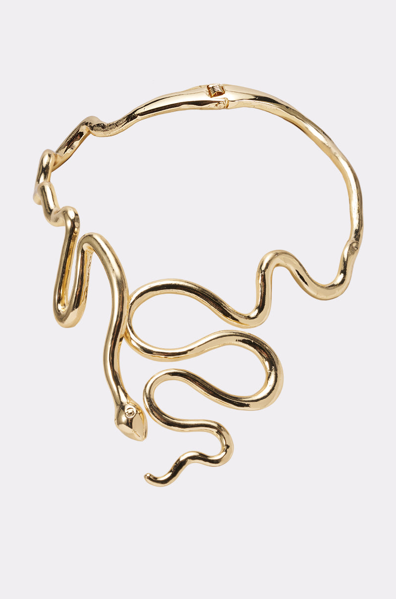 The WINDING SNAKE STATEMENT NECKLACE features a sculptural coiled design with a smooth gold finish and detailed snake head, making it a bold and striking accessory for any occasion.