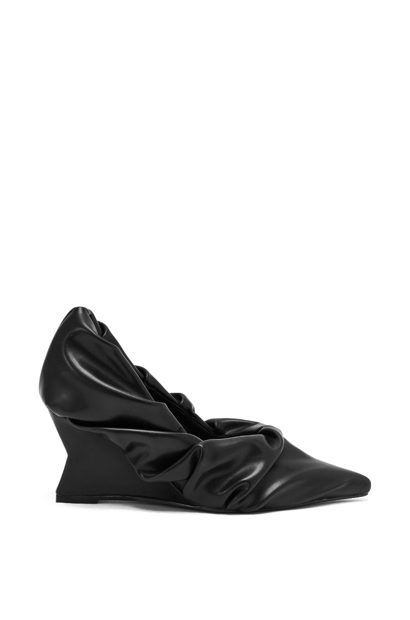 The AZALEA WANG AICHA BLACK RUCHED WEDGE PUMP is a black faux leather shoe with a pointed toe and distinctive gathered upper, shown on a plain white background.