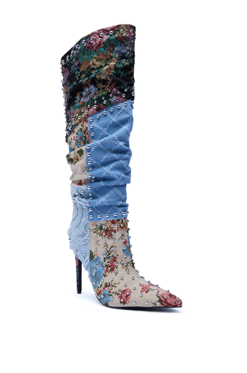 The AZALEA WANG AILA DENIM MULTI STUDDED POINTED TOE STILETTO BOOT features a knee-high patchwork design with floral embroidery, quilted blue denim, studded accents, and a pointed toe to elevate any look.