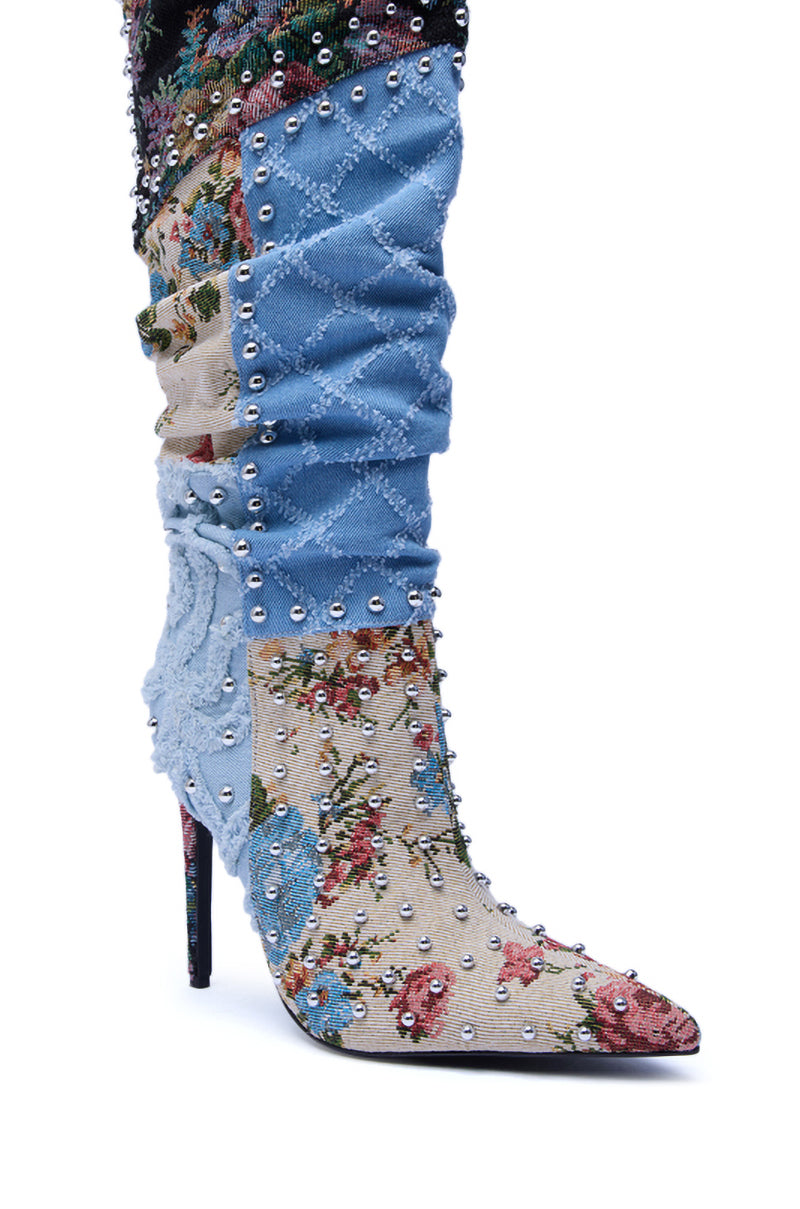 The AZALEA WANG AILA Denim Multi Studded Pointed Toe Stiletto Boot is knee-high, with a pointed toe, blue and floral fabric, silver studs, textured stitching, and a multicolored floral pattern on the lower part.