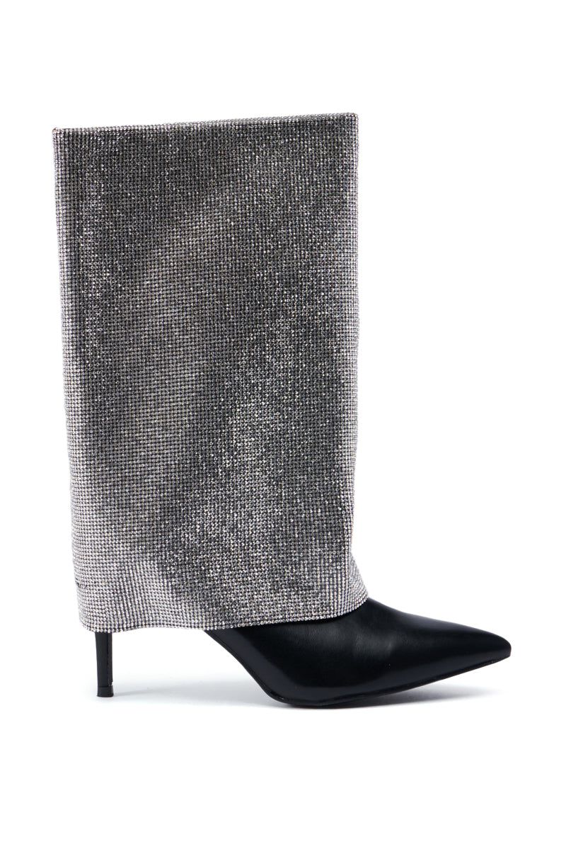 Introducing the AZALEA WANG AISLING BLACK SPARKLE COVERED HEEL BOOT, a sophisticated high-heeled boot featuring a pointed toe. The base of the boot is crafted from faux black leather, while the upper part boasts shimmering silver fabric that drapes gently like a soft sock. The stiletto heel enhances this chic design with an elegant flair. 2