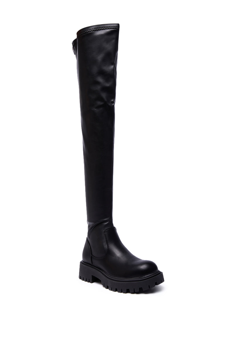 The AZALEA WANG AJUNA Black Flat Thigh High Stretch PU Boots feature a round toe and chunky sole, displayed upright on a white background.