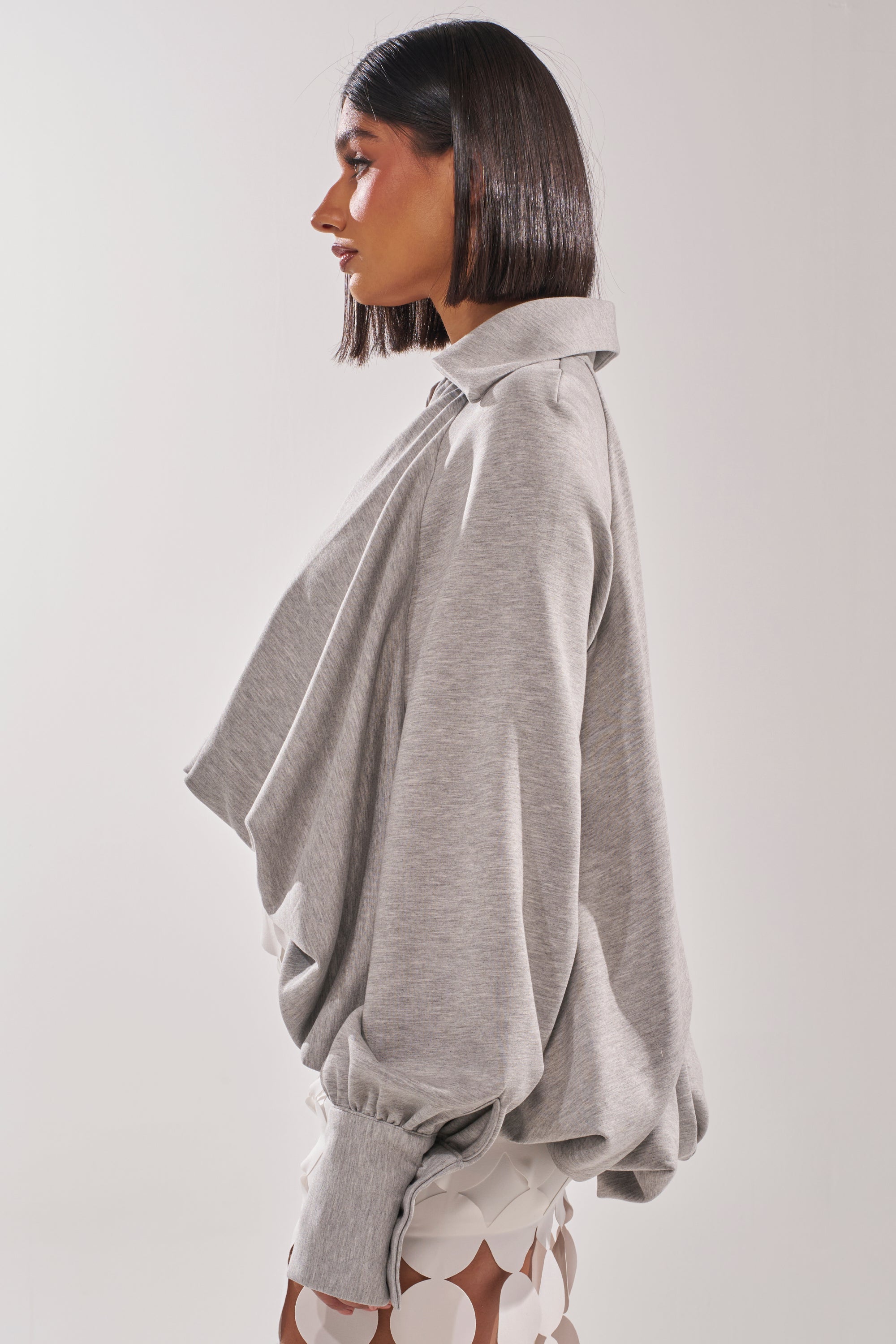 A woman in the NEW RULES HIGH LOW BLOUSE in grey. 3