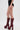 Someone models the TOO HOT TO HANDLE LACE HOT SHORT with tall, maroon platform boots featuring chunky heels and a lace-up front, all set against a plain white background.