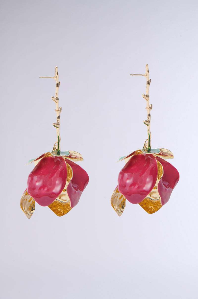 Discover the IN BLOOM EARRING, designed with a faux gold metallic base and rose dangle silhouette. These earrings feature intricate red and gold floral designs with stems and leaves, offering an artistic touch against a plain gray backdrop. 3