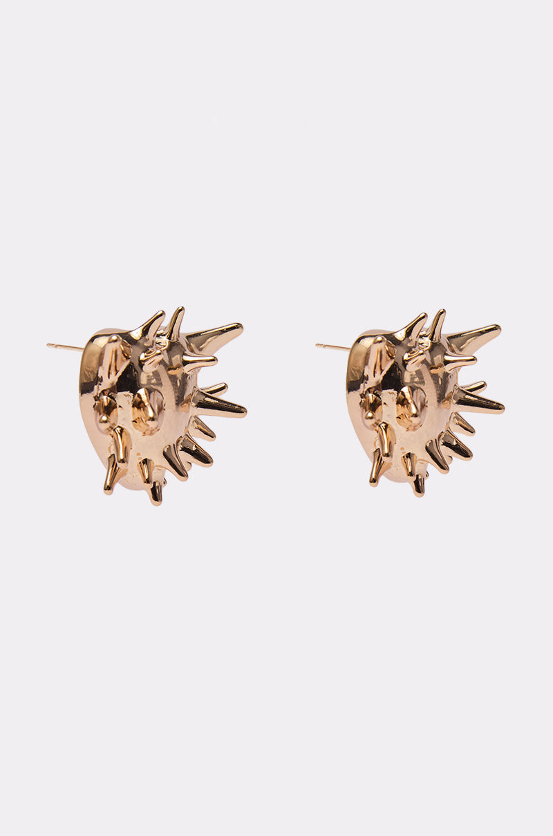 TOUCH ME I DARE U EARRING: Gold-tone earrings shaped like stylized suns with abstract spiky rays extending outward, displayed on a plain white background. 2