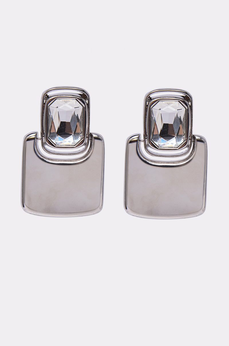 The MOD EARRING features silver-toned geometric design with large square bases and faceted rectangular clear gemstones at the top, shown against a plain white background. 0