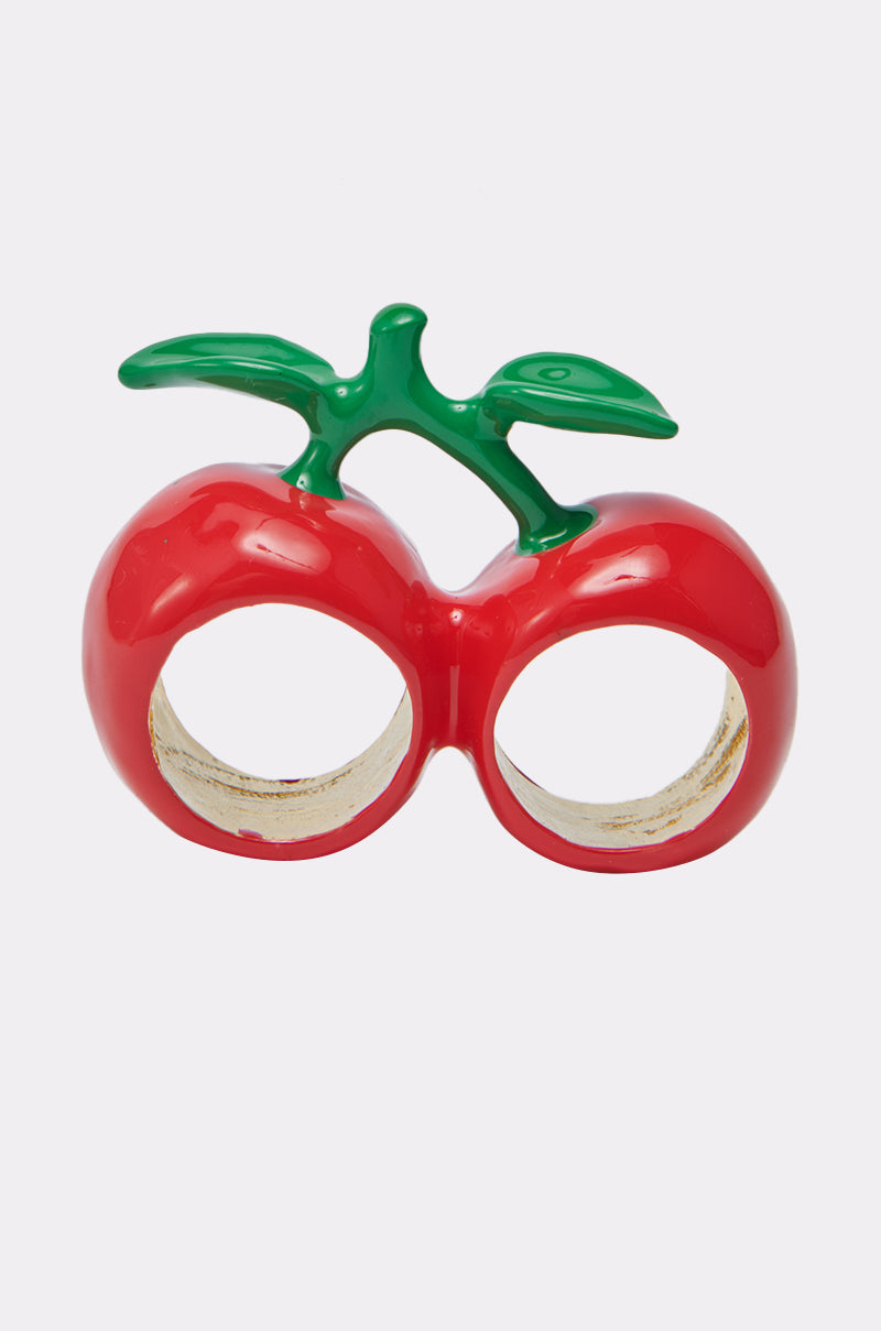 The CHERRY BOMB RING is a playful double-finger accessory featuring two glossy red cherries with green stems and leaves, shown against a plain white background.
