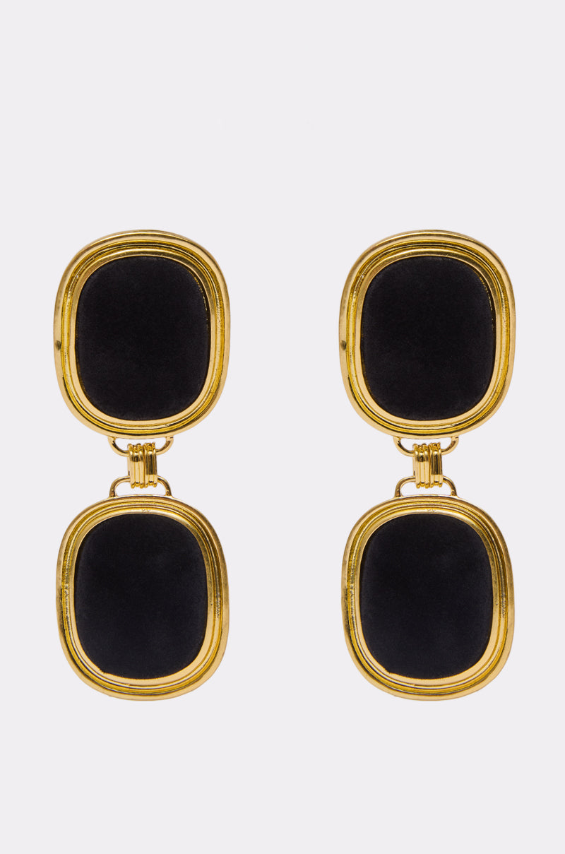 The ART DECO EARRING is a pair of earrings with two rectangular black stones each, set in gold frames with rounded corners, displayed against a plain, light background. 0