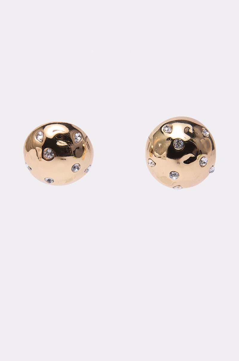 A pair of round, gold-toned PARI EARRINGs from AKIRA Label, adorned with small clear rhinestones, displayed on a plain white background.