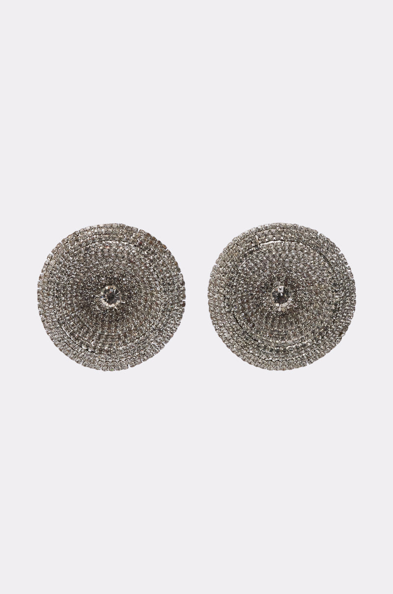 The U WISH EARRING is a pair of round, silver-toned oversized earrings featuring a textured spiral pattern, shown against a plain light gray background. 0