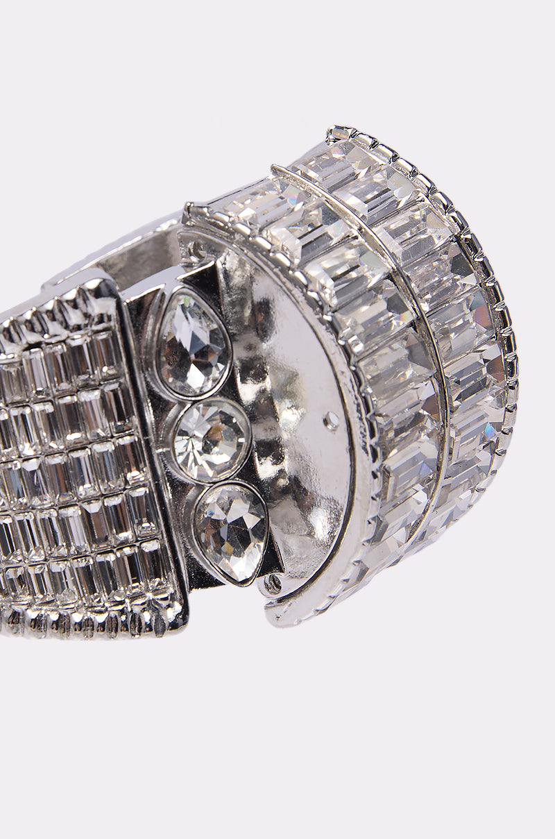 Close-up of the DIAMONDS DANCING BRACELET, a wide-band silver piece with a grid pattern, baguette-cut rhinestones, round clear gemstones, and reflective surfaces, highlighted by its elegant clasp.