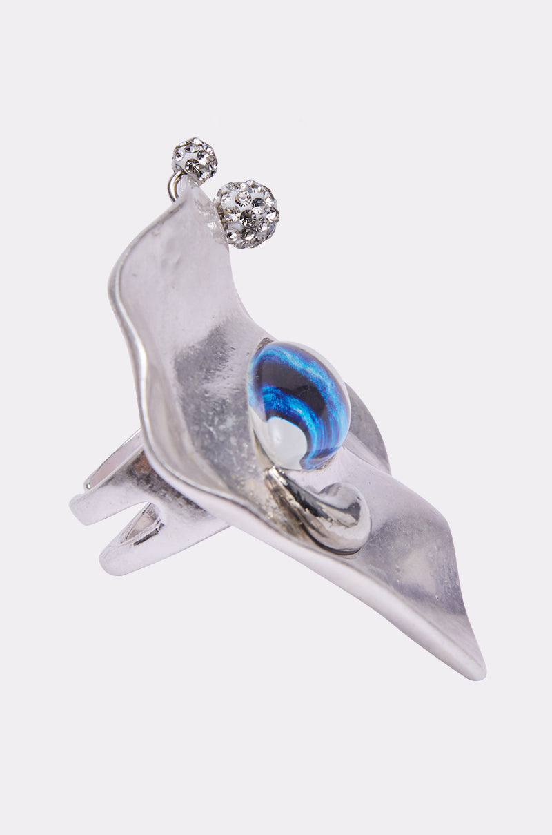 The EYE SEE YOU RING features a silver-tone wavy abstract design, a central round blue and white glass bead, and two textured silver balls—perfect for making a bold statement. 2