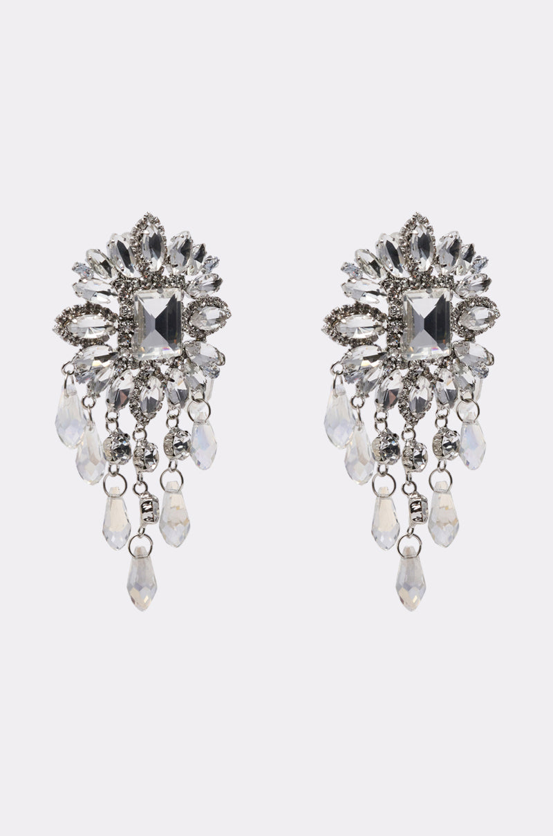 THE MAIN MOMENT EARRING: Ornate silver chandelier earrings with a central square gem, sparkling accents, and teardrop crystal dangles in a floral-inspired design—perfect statement bridal earrings.