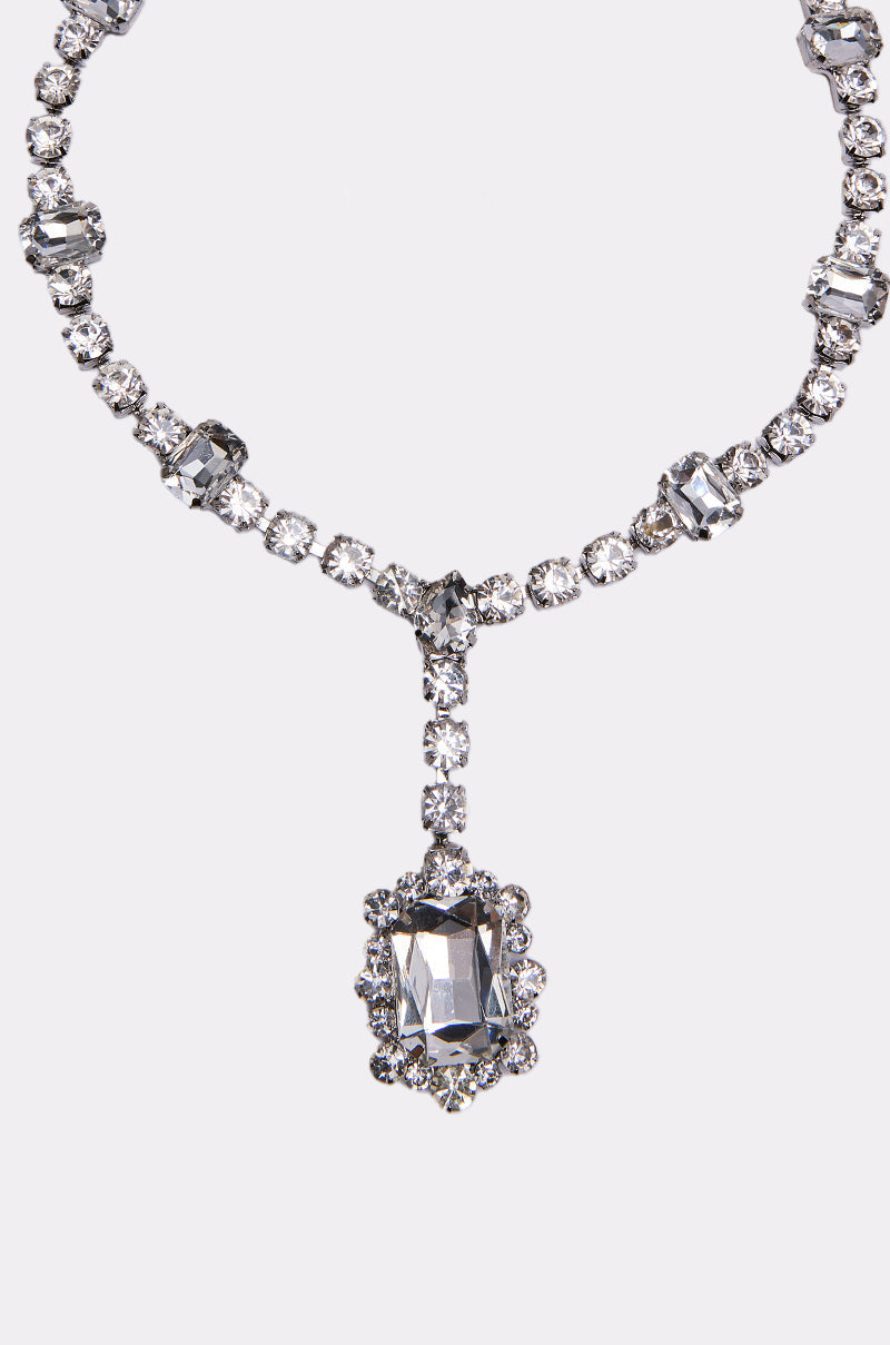 The FOR THE RECORD BLING NECKLACE features sparkling crystal rhinestones with round and rectangular clear gemstones, highlighted by a large rectangular pendant framed by smaller gems, all set in silver-tone metal. 2