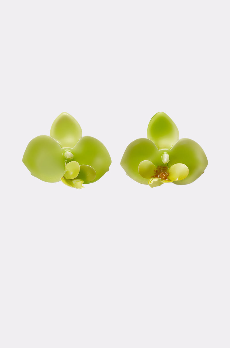 The TAKE ME OUT EARRING is a pair of lime-green acrylic earrings inspired by orchids with yellow accents, shown against a plain white background. 2