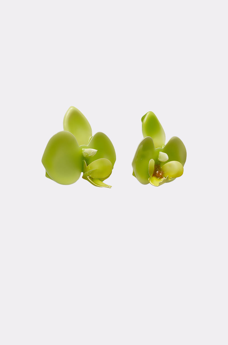 Two small, bright green succulent leaves on a plain white background mirror the smooth, rounded shape and glossy texture of the TAKE ME OUT EARRING. 4