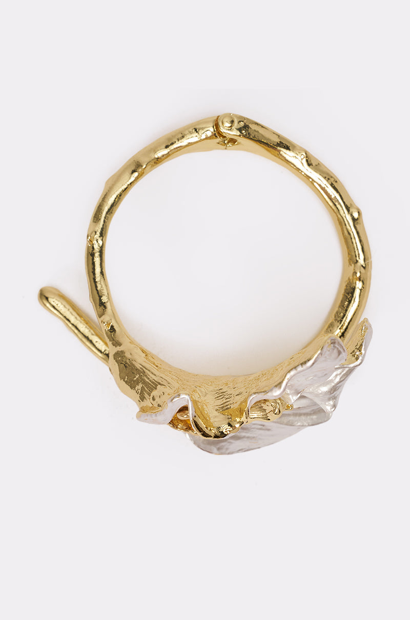 The TERRI BRACELET features a gold and silver cuff design with a textured, organic band and a wavy silver accent on one side, shown on a plain white background. 3