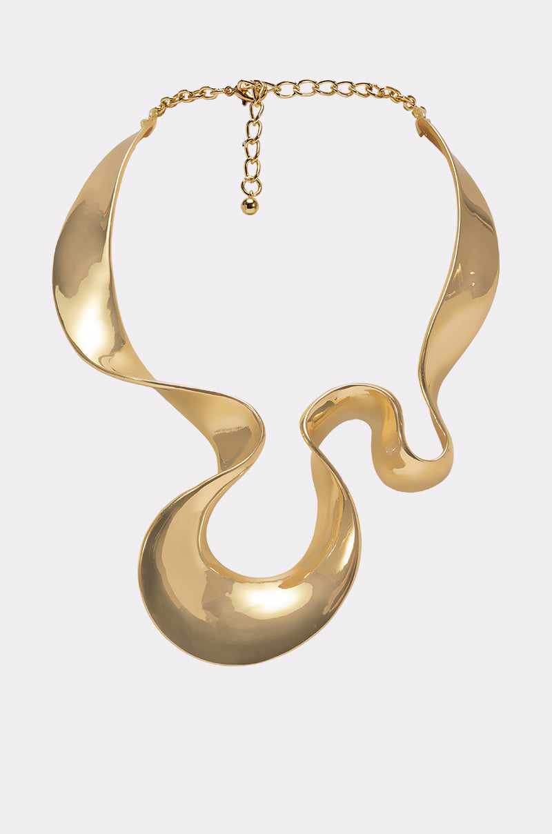 The PURE VIBES NECKLACE features a high-polish gold finish, bold abstract wavy design, and adjustable chain clasp, showcased against a plain light background. 0