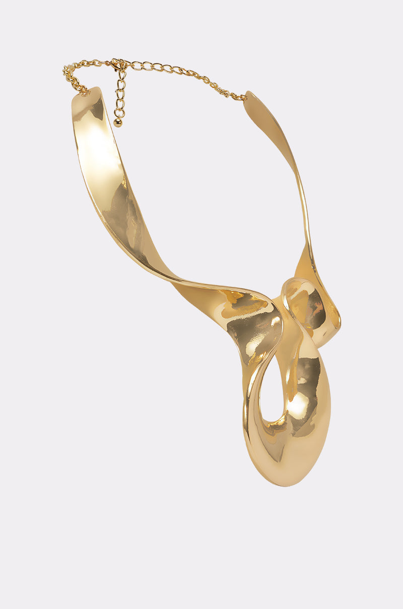 The PURE VIBES NECKLACE is a sculptural gold collar with abstract, fluid curves and a high-polish finish, featuring an adjustable chain closure, shown on a plain white background. 2