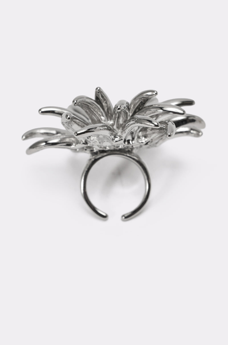 The JENNY SILVER RING is a spiked statement piece with an adjustable band, showcasing an abstract starburst design and multiple curved, pointed extensions radiating outward. 5