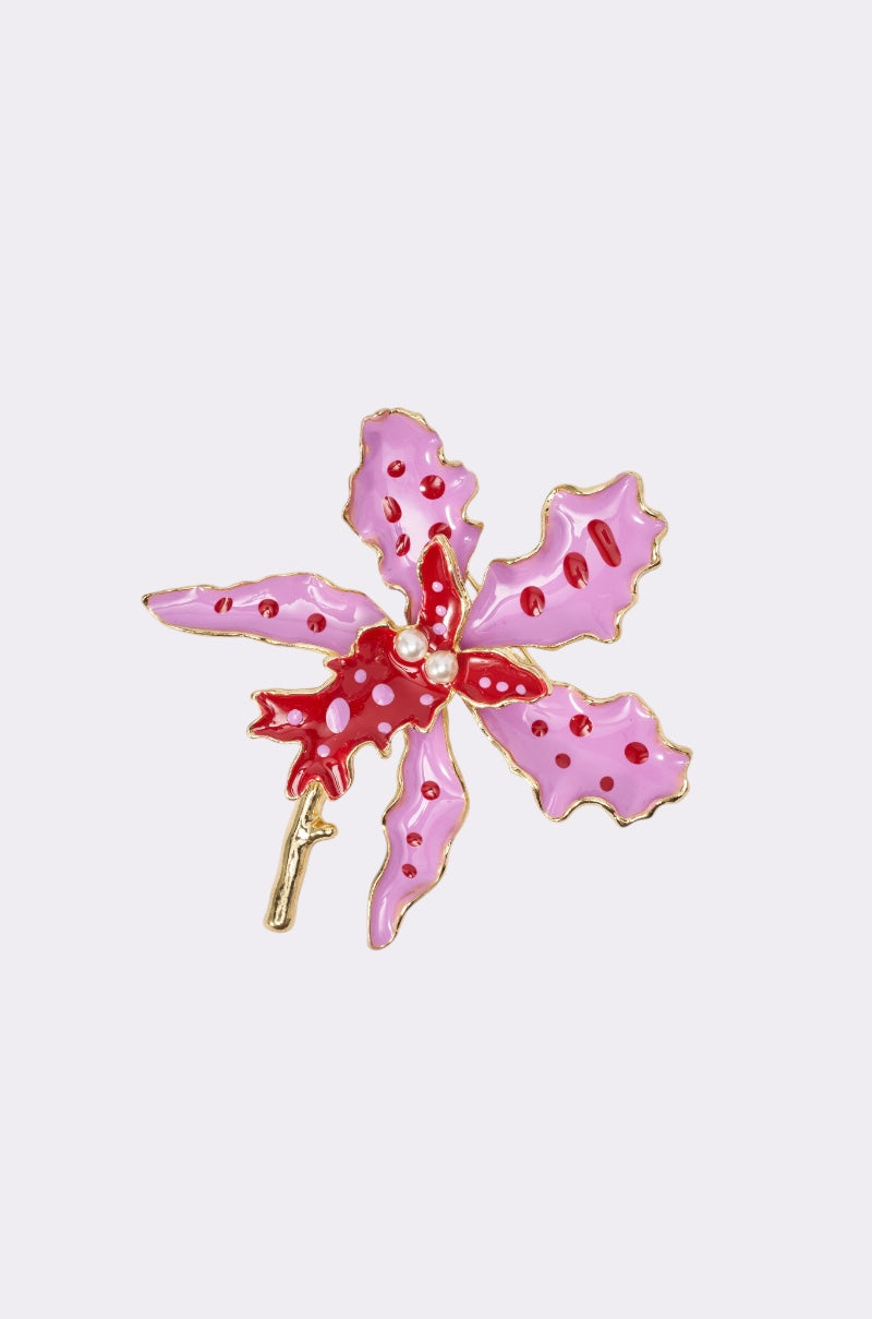 The EPITOME OF BEAUTY BROOCH features a pink and red five-petal flower with gold outlining and a small stem, displayed on a plain light background. 1