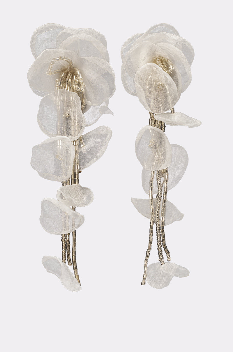 The IN YOUR DREAMS EARRING features delicate, layered translucent white petals and gold-toned beaded strands that cascade down, evoking the look of abstract flowers or orchids. 0
