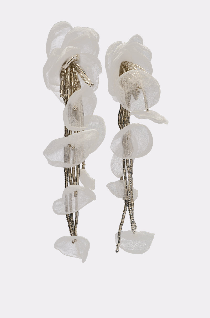 The IN YOUR DREAMS EARRING features long, dangling statement earrings with delicate white fabric petals and silver-toned strands, creating a sheer floral drop design that resembles cascading flowers for an elegant touch. 2