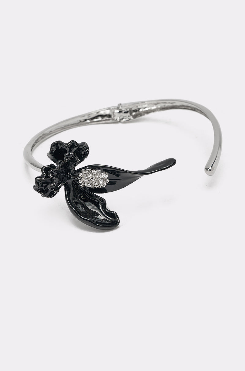 The FULL BLOOM NECKLACE showcases a silver chain with a black sculpted flower pendant accented by a cluster of sparkling clear stones—ideal for statement jewelry lovers. 1